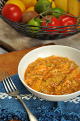 Fried cabbage in white bowl. Vegetables on background
