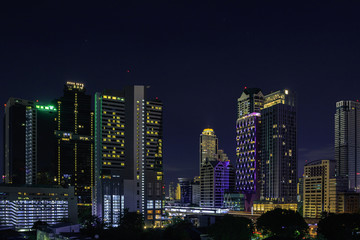 Fototapeta na wymiar Cityscape at night in bangkok with tower and road, twilight sky