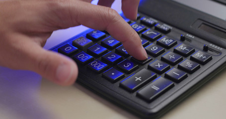 Man working on calculator