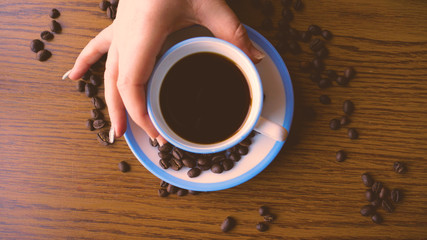 Fototapeta na wymiar Cup with coffee and coffee beans
