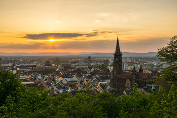 Germany, Romantic sunset light over roofs of city Freiburg im Breisgau