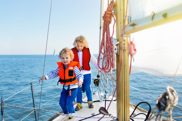 Kids sail on yacht in sea. Child sailing on boat.