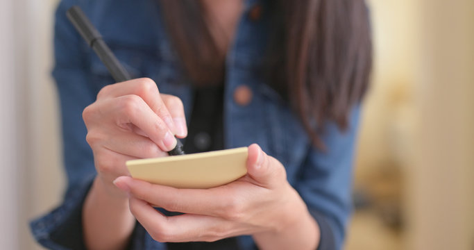 Woman jotting note