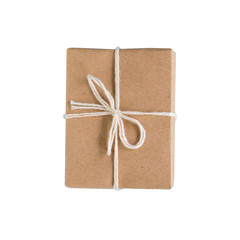 A handmade gift wrapped in kraft paper. Isolate on white background.