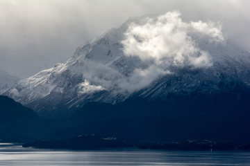 Clouds covered snowy mountain above Halibut Cove Alaska
