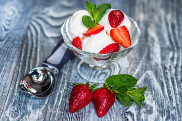 Strawberry ice cream in bowl and strawberries