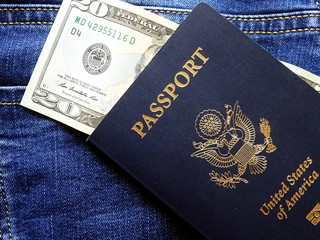 American passport and 20 dollars against jeans