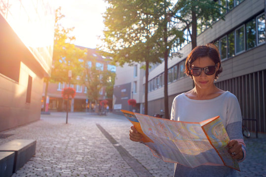 Woman with map in the street.