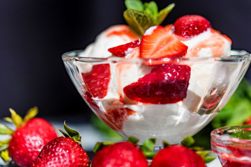 Strawberry ice cream with mint in bowl and jam