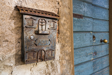 Old mailbox and door in the upper town of Bergamo