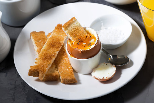 boiled egg, toasts and coffee for breakfast, closeup top view