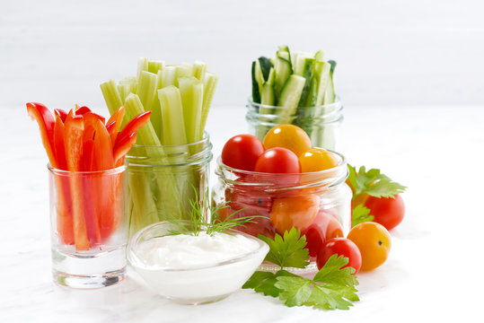 healthy snacks, mixed vegetables and yogurt on a white background, closeup