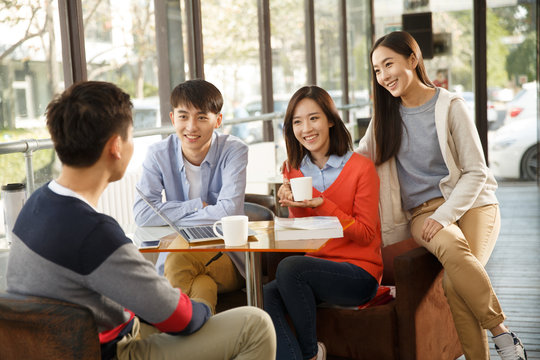 Young men and women in the coffee shop - Powered by Adobe