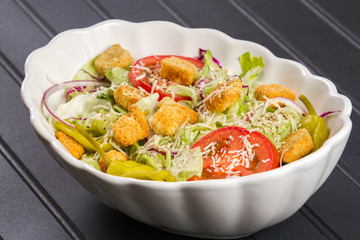 Green Salad in White Bowl on Black Table