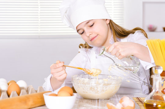 Cute girl cooking  in the kitchen