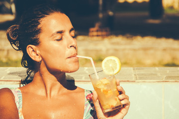 Woman drinking a cocktail in the summer