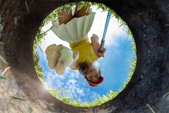 View From Bottom Of The Golf Hole, Golf Ball In Hand Of Woman Player Takes Out From The Hole After Completed Putting Winner In Shot