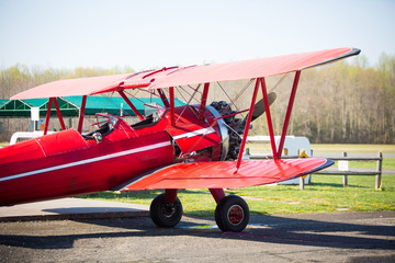Vintage red plane ready to fly on the field