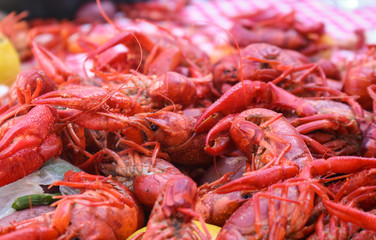 Crawfish boil - cooked seafood and vegetables piled on a red and white checked tablecloth