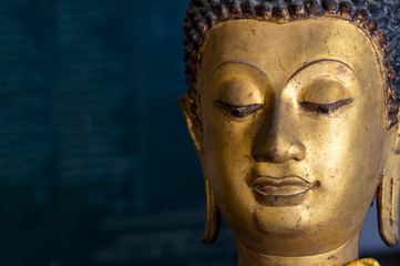Close up of Buddha statue face on dark background used as amulets in Buddhism religion