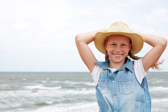 Happy child on a turquoise sea background. Recreation concept - positive emotions. Horizontal photo