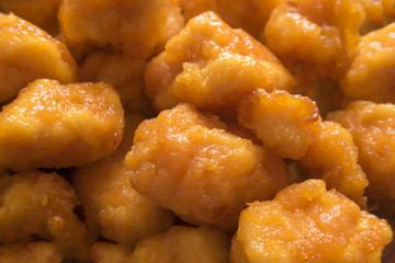 Appetizing and tasty fried chicken pieces in battered close-up