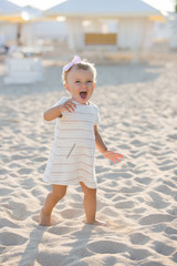 Portrait of happy little girl. Sand beach in the summer