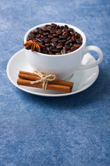 Cup of coffee seeds cinnamon anis close up
