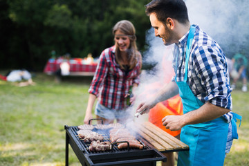 Young people grilling outdoors