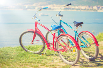 Fototapeta premium Two bright bicycles on the background of the sea