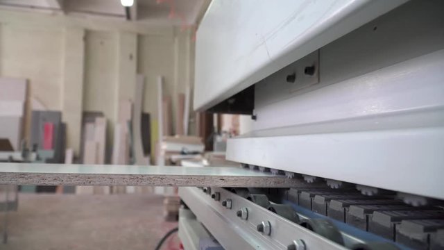 Manufacture of furniture on the machine.Format machine for cutting chipboard, MDF, process of chipboard cutting