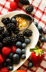 Macro view of blackberries, blueberries, raspberries and muesli