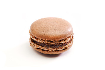 Fresh baked brown Macarons, or macaroons isolated on white background