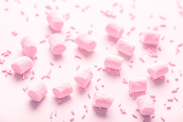 beautiful marshmallows and sprinkles, soft pink background for holidays