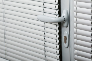 door handle on a gray door with shutters