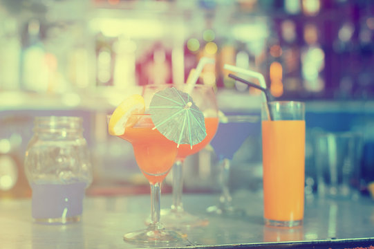 Image of various colorful cocktails on the bar counter