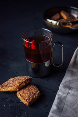 Glass cup of tea with biscuits