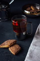 Glass cup of tea with biscuits