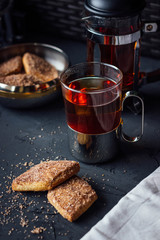 Glass cup of tea with biscuits