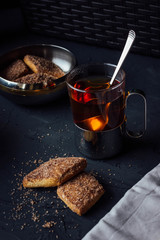 Glass cup of tea with biscuits