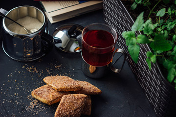 Glass cup of tea with biscuits and honey