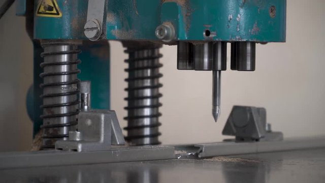 Bending flat metal then make a hole at flat bar by drilling machine. lose up tool of automatic drilling machine make hole at metal with cooling by coolant water and evaporate to steam