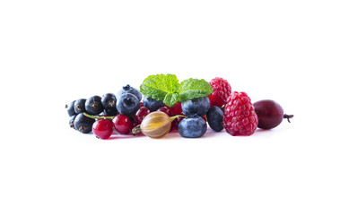 Fruits and berries isolated on white background. Ripe currants, blueberries, raspberries and gooseberries with a leaf of mint. Sweet and juicy fruits with copy space for text. Top view.