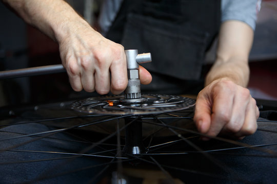 Photo workshop for repairing bicycle wheel.