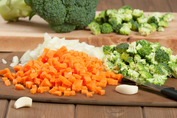 Obraz na płótnie Canvas Cut Vegetables. Broccoli, Carrot, Onion, Garlic. Cooking Process. Raw Ingredients.