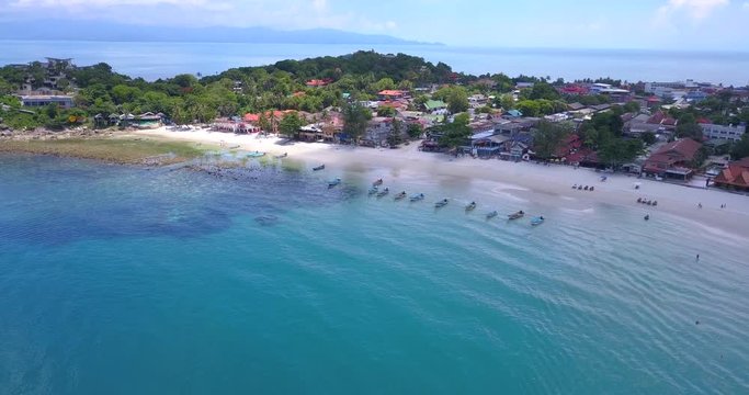 Aerial 4K: Haad Rin beach line,taxi boats area,aerial cinematic view from the drone, Phangan island, Thailand