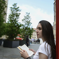 Young beautiful dark-haired girl model appearance in an old town in the spring.