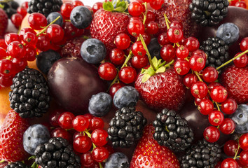Ripe blackberries, blackberries, strawberries, red currants, peaches and plums. Mix berries and fruits. Top view. Background berries. 