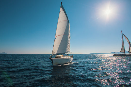 Sailing in the wind through the waves at Sea. Luxury yachts.