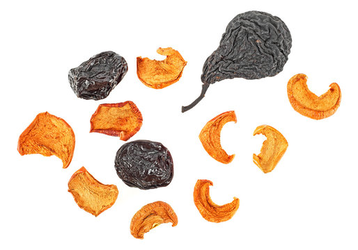 Dried fruits on a white background - pears, apples and prunes. Top view.